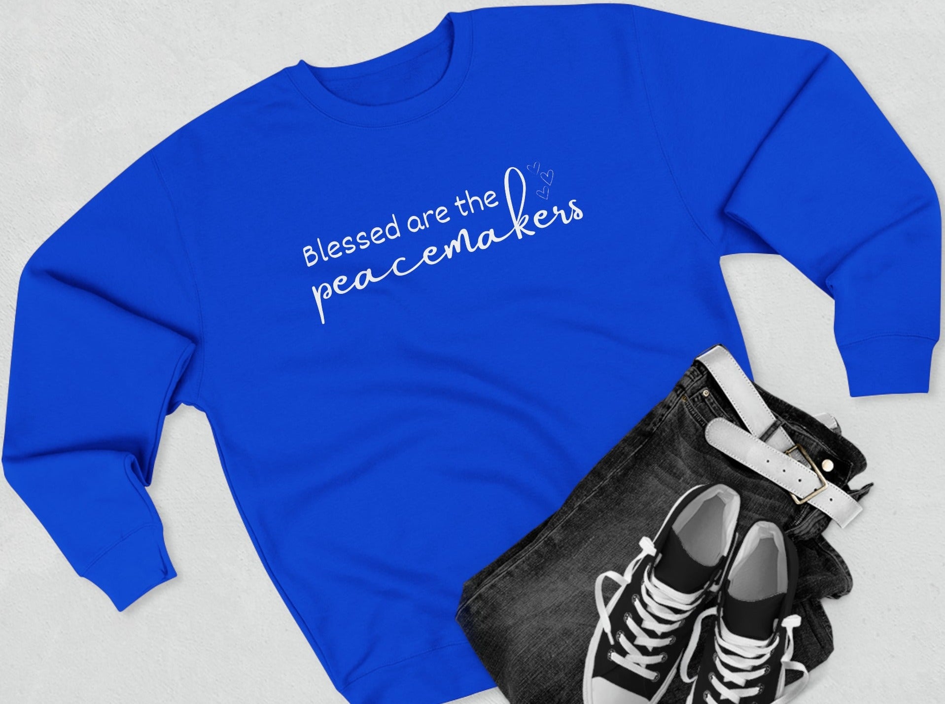 Blessed are the Peacemakers, Unisex Crewneck Christian Sweatshirt laying flat royal blue
